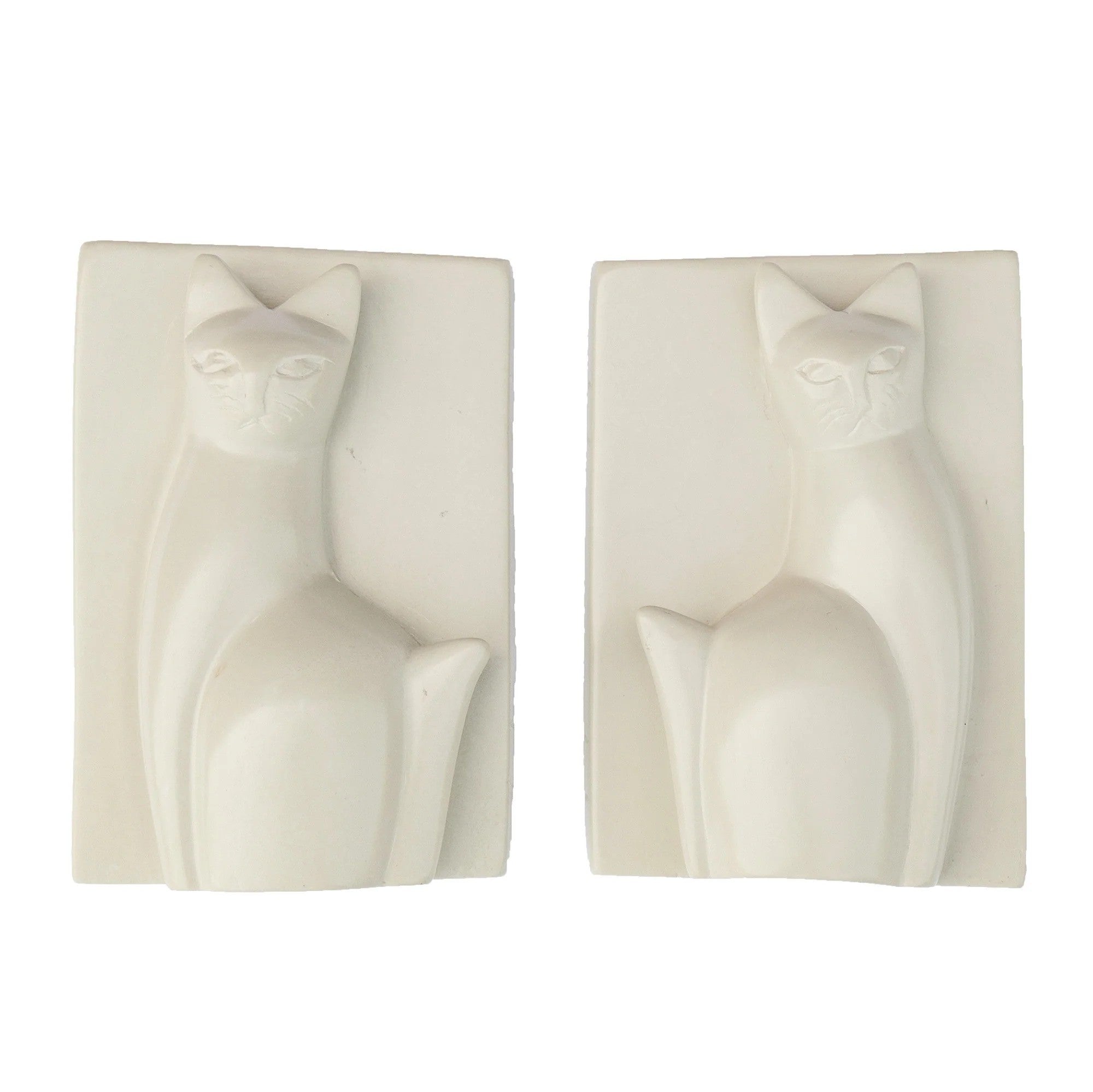 Two carved soapstone bookends in the shape of a sitting cat, with a white and natural color variation