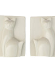 Two carved soapstone bookends in the shape of a sitting cat, with a white and natural color variation