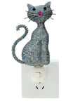 Decorative cat-shaped night light on a white background