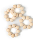 A set of beige wooden napkin rings arranged on a white background