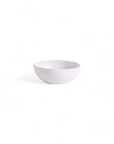 A small, white stoneware condiment bowl against a plain background