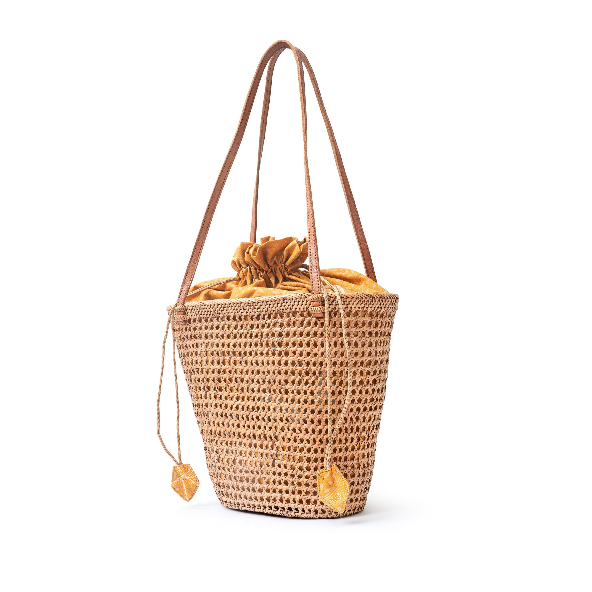 Side view of a brown rattan mesh tote shopper bag with shoulder straps and a drawstring top closure.