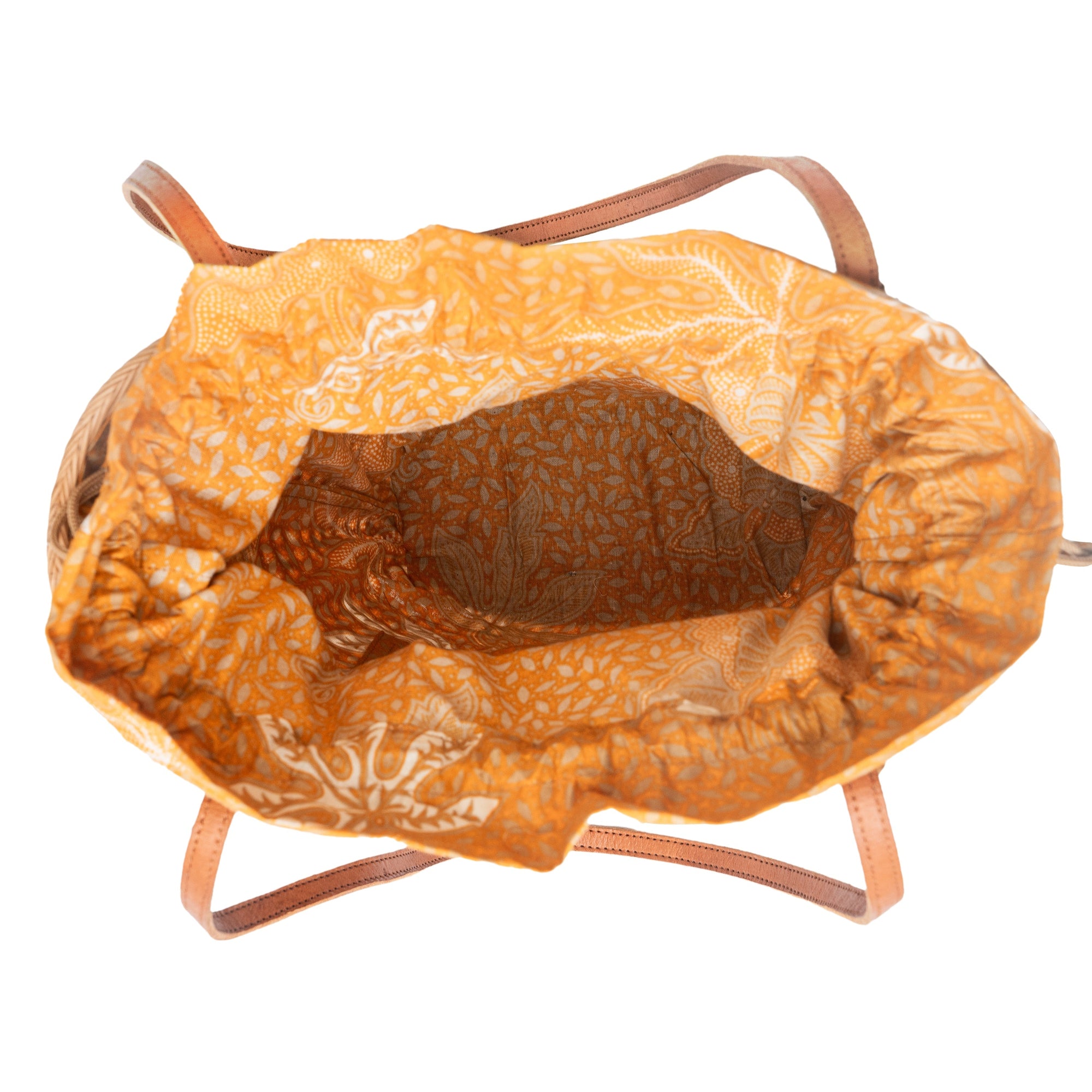 Overhead view of a brown rattan mesh tote shopper bag with shoulder straps and a drawstring top closure.