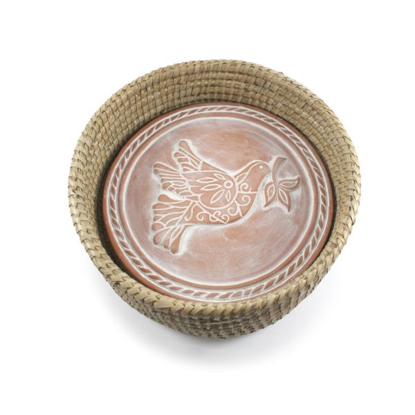 A handwoven terracotta bread basket with a peace dove design bread warmer stone inside