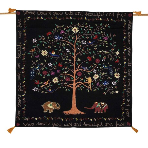 A wall hanging decor featuring an embroidered tree with birds, monkeys, and elephants, alongside a bamboo textile hanger