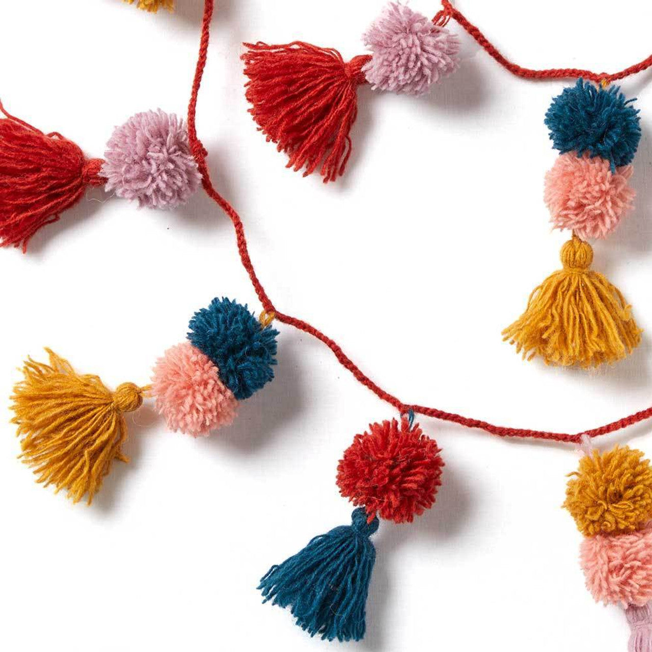 Colorful tassel and pom-pom garland on a white background