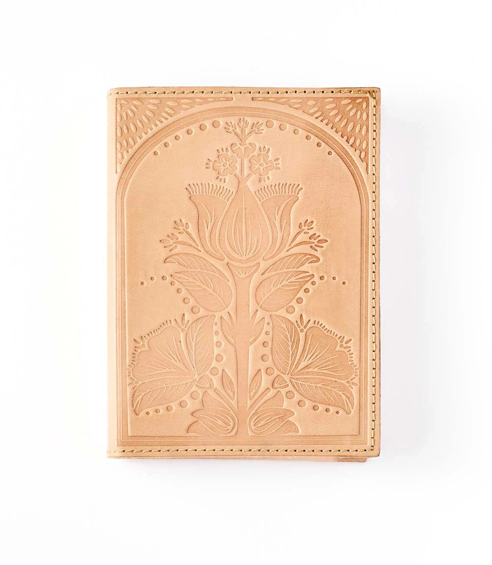 Decorative leather embossed panel with floral design on a white background