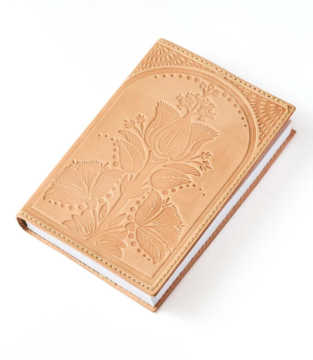 Leather notebook with floral embossing on a white background