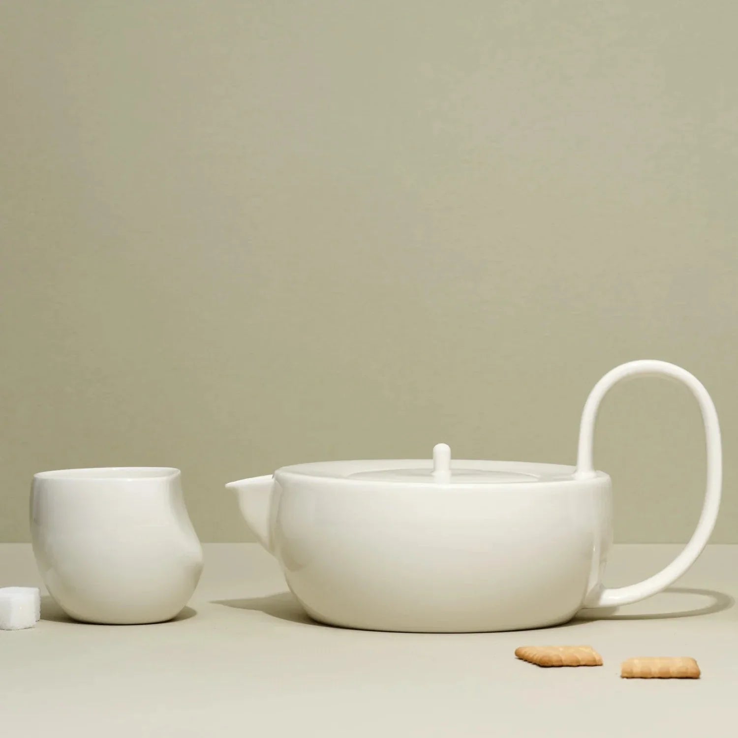 A white ceramic teapot set with two medium-sized cups on a light background, part of the Large Ceramic Teapot Set