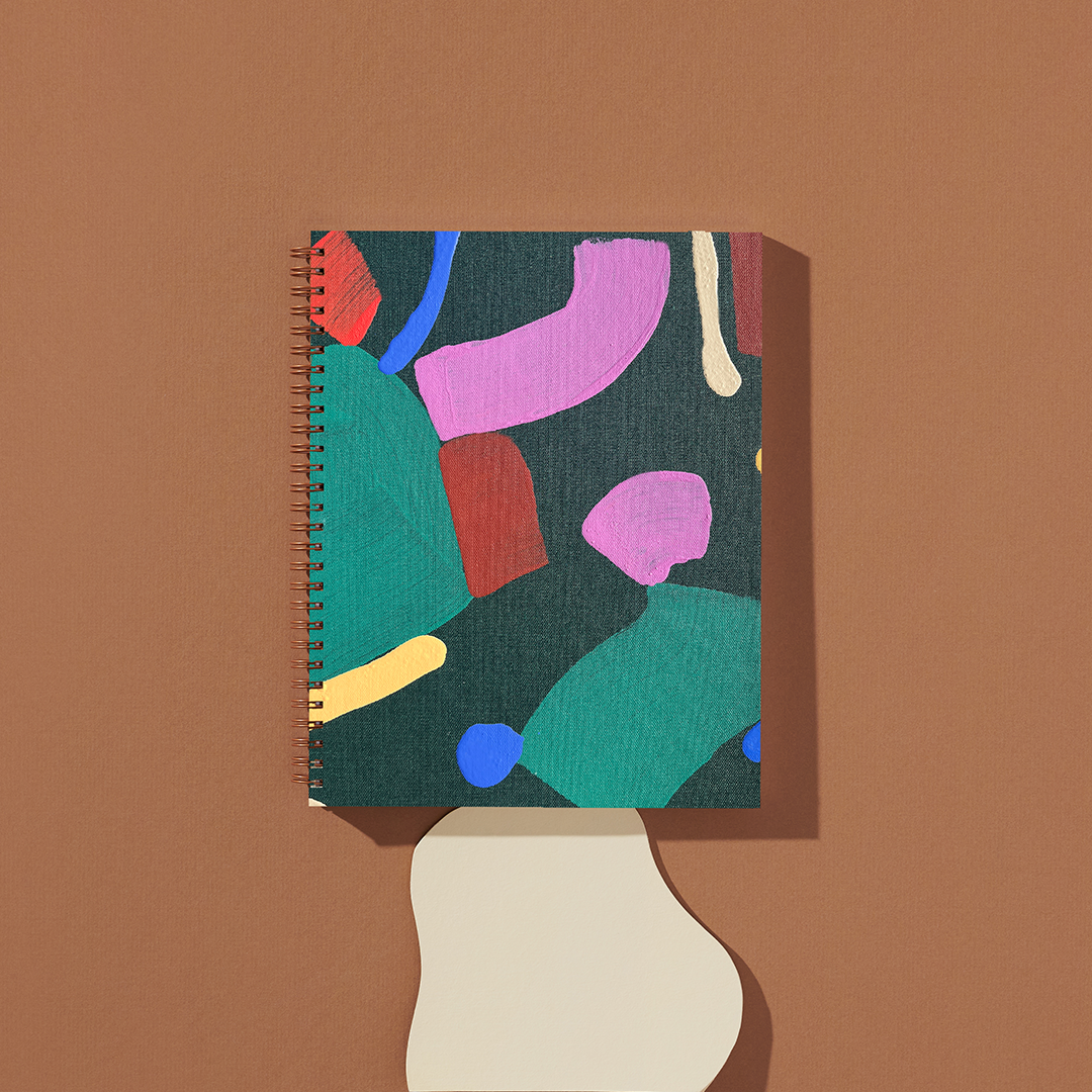 Notebook with abstract colorful design on a brown background