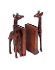A pair of hand-carved wooden giraffe bookends with a dark brown finish