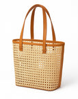 Woven tote bag with brown handle and trim on a white background