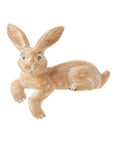 A hand-carved wooden shelf sitter in the shape of a hare with a whitewashed finish