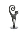 A black metal cat figurine standing on a round base, with its tail curled upward in a spiral, shown against a plain white background.