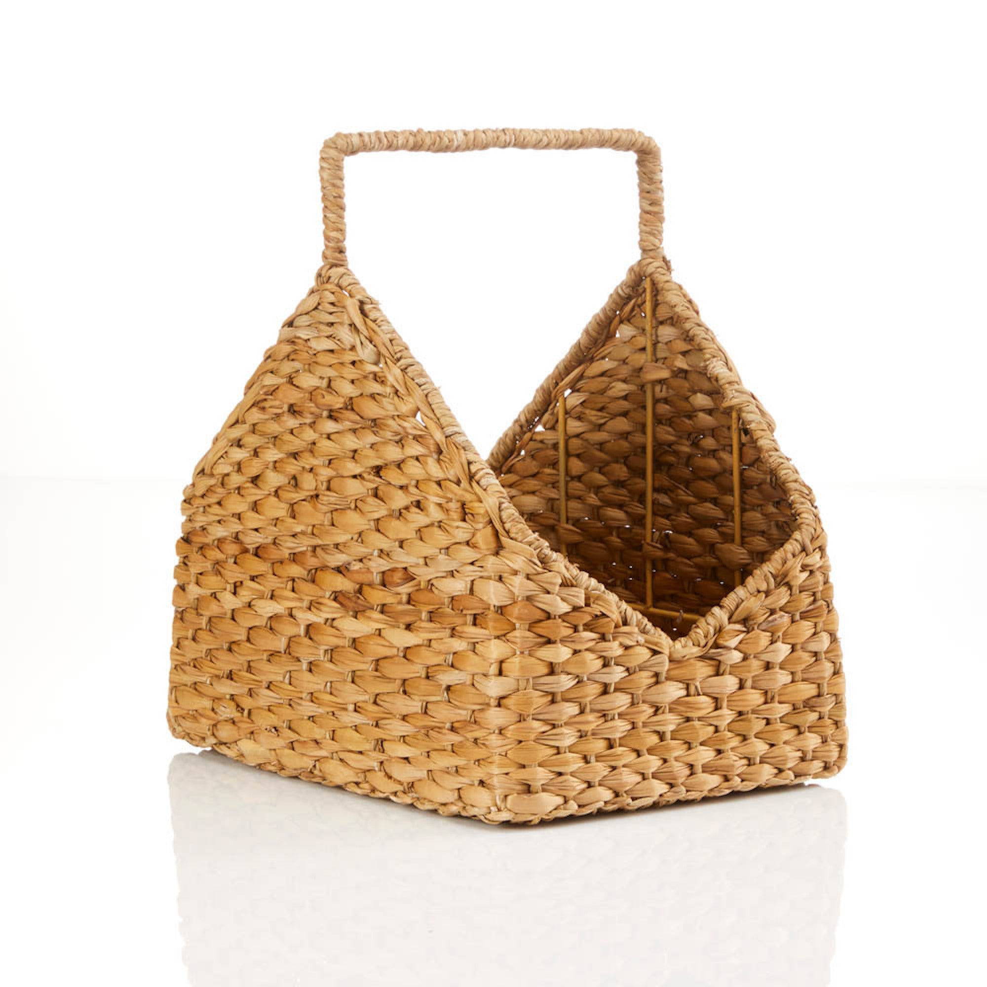 A rustic log basket made of hogla grass with a handle