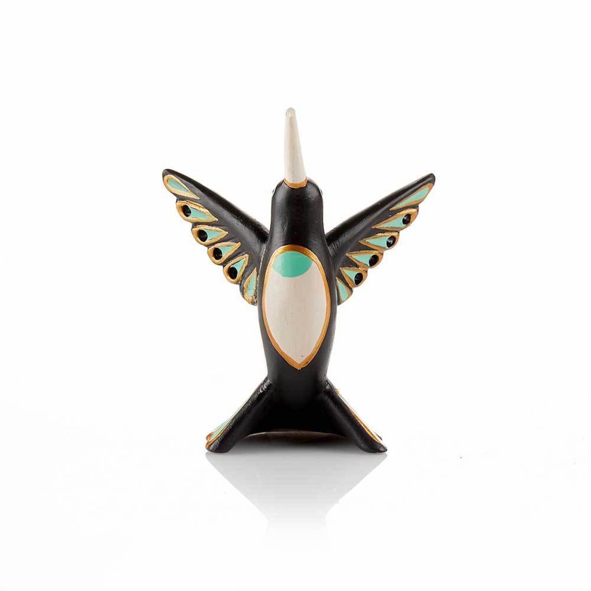 The front of a hand-painted ceramic jewelry holder in the shape of a hummingbird holding rings and earrings.