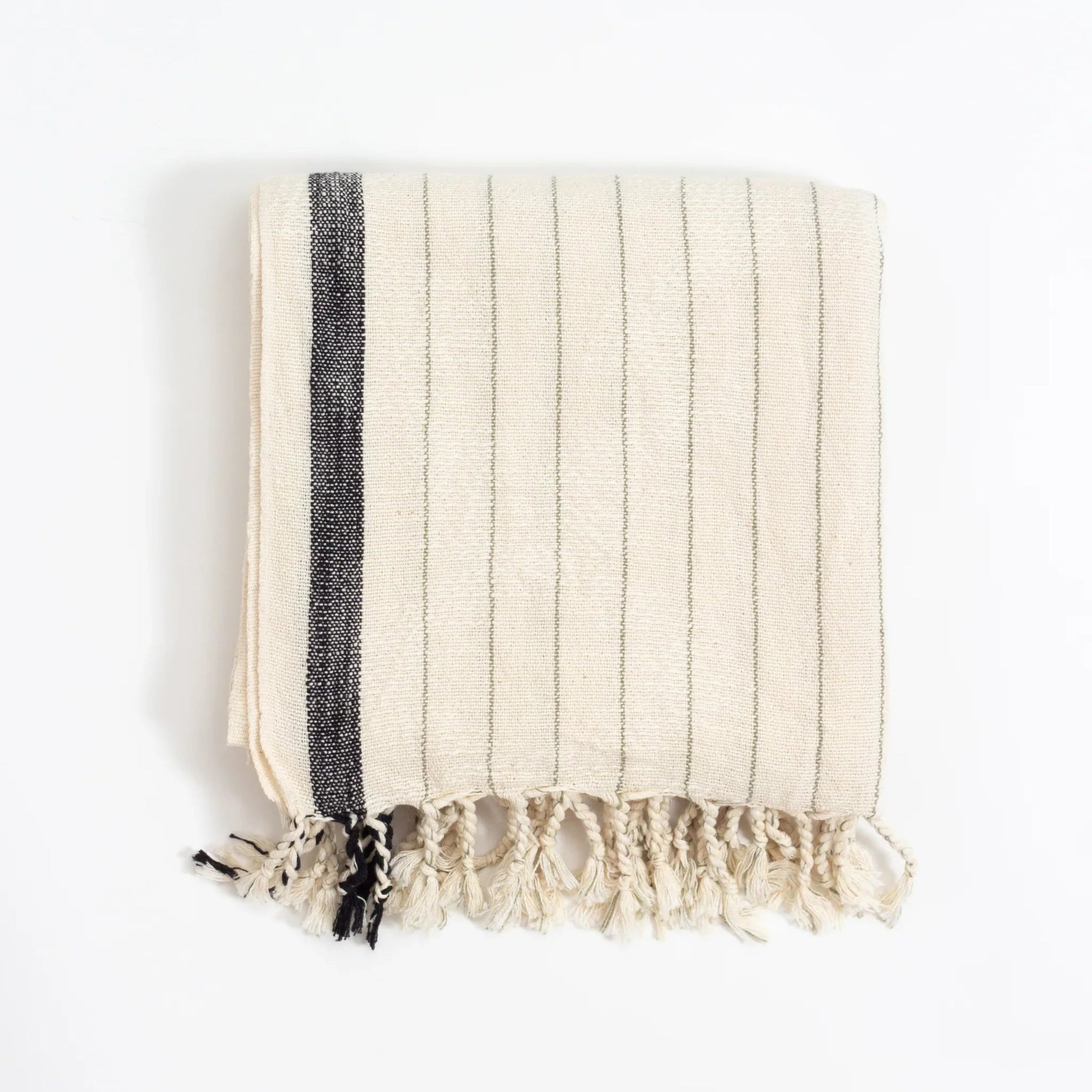 Beige towel with a black stripe and fringes on a white background