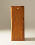 Brown wooden cutting or serving board displayed on a gray and white background