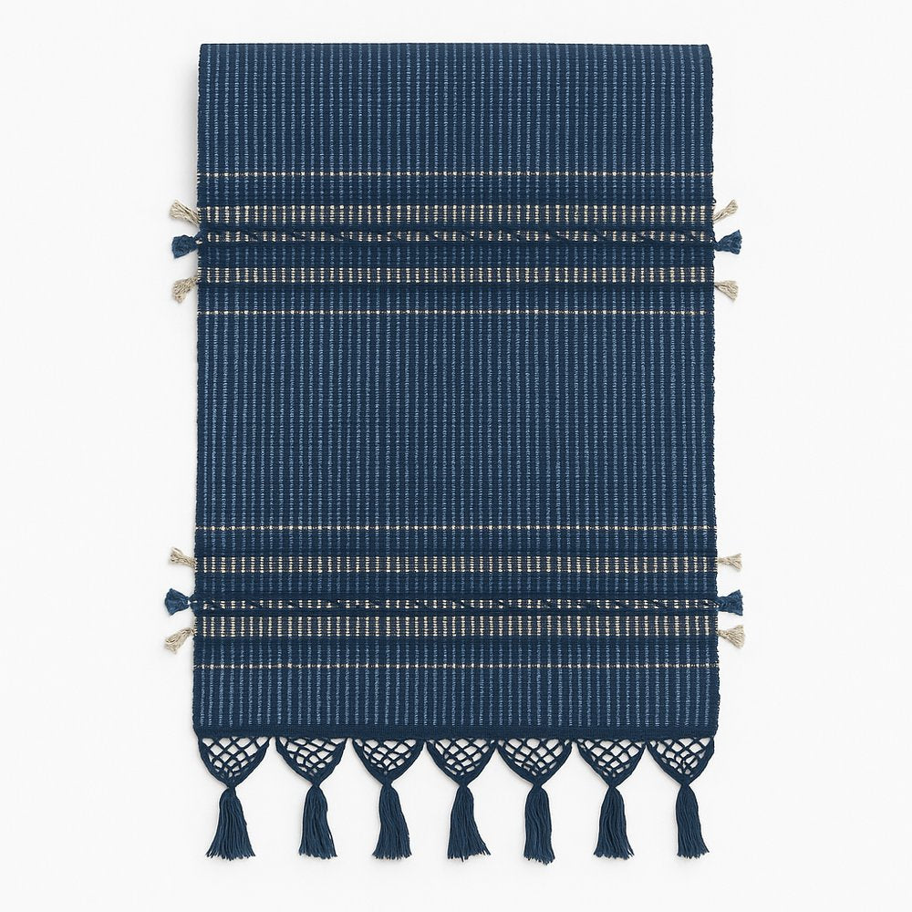 Navy blue woven table runner with decorative tassels on a white background