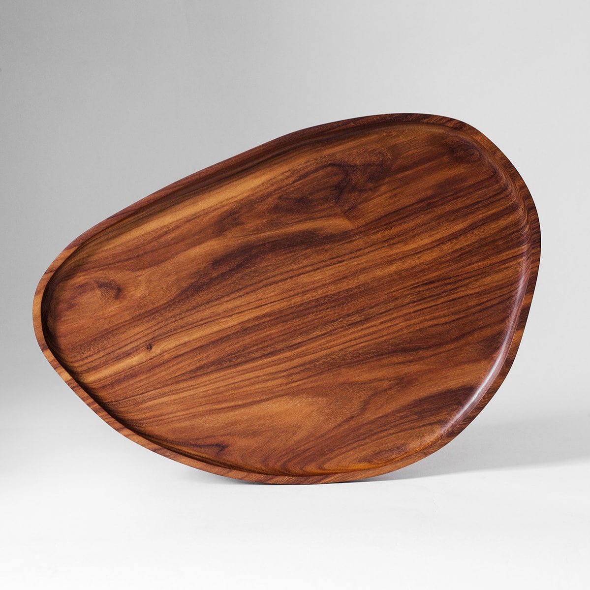 An oval-shaped, brown wooden tray with a smooth finish, displayed against a neutral background