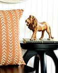 A handcarved lion sculpture made of jacaranda wood displayed on top of a stool