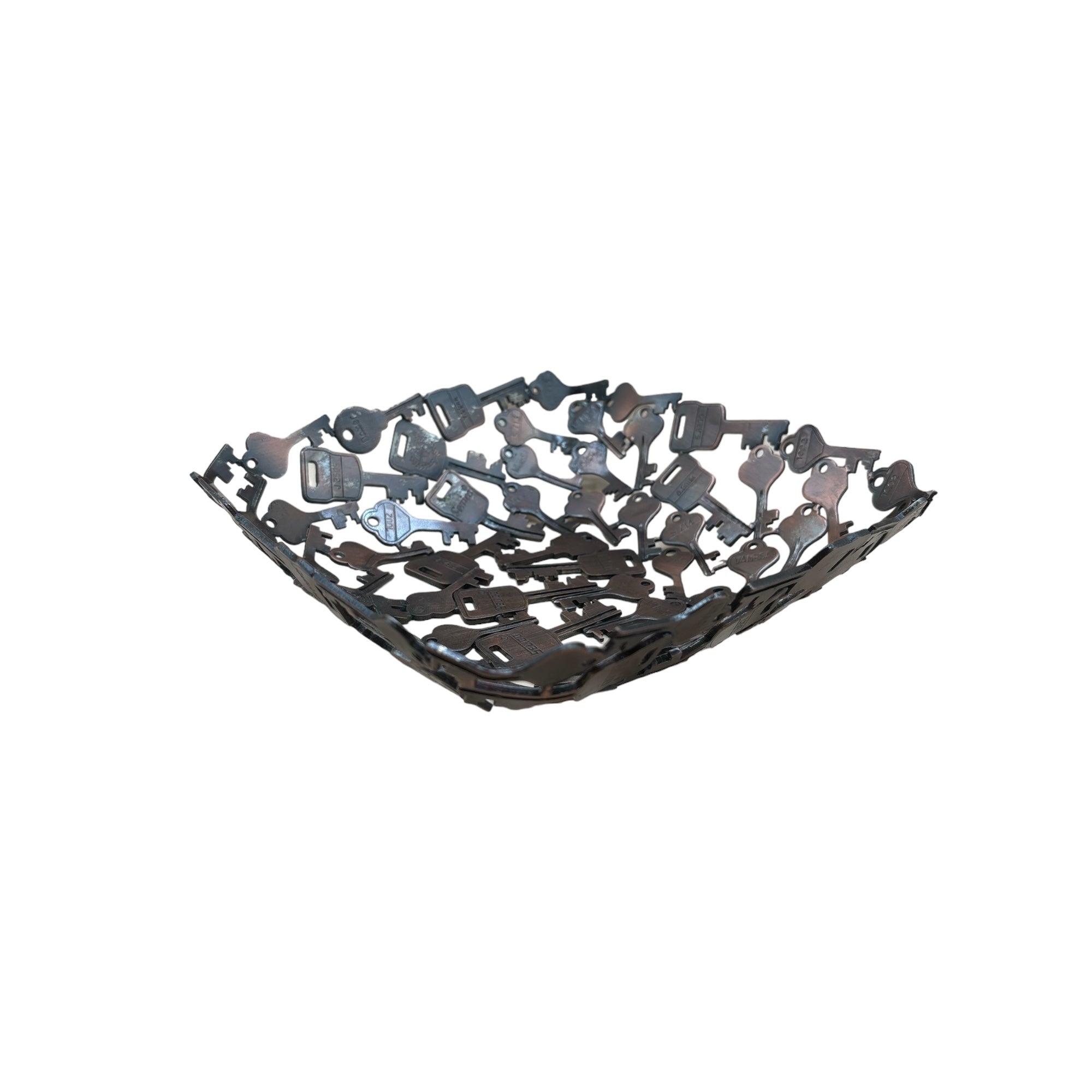 A handcrafted decorative bowl and trinket dish made of assorted recycled iron keys with a copper-colored finish.