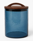 Blue glass jar with a wooden lid on a white background