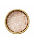 A terracotta bread warmer with a handwoven kaisa grass basket and a lotus design incised into the stone surface.