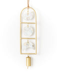 Decorative wind chime with gold frame and mother of pearl shells on a white background