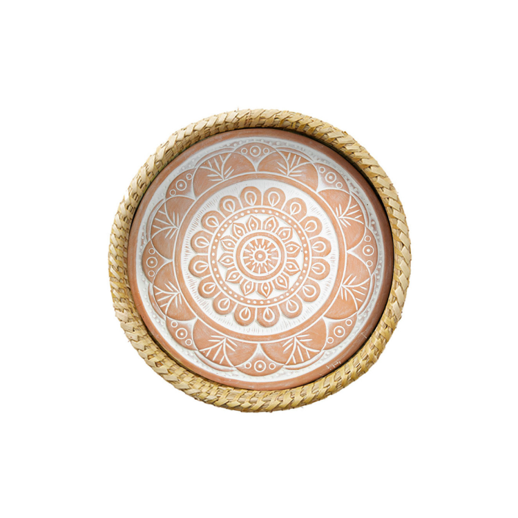 A terracotta bread warmer with a mandala-inspired geometric pattern, handwoven basket with palm wrap.