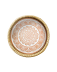 A terracotta bread warmer with a mandala-inspired geometric pattern, handwoven basket with palm wrap.