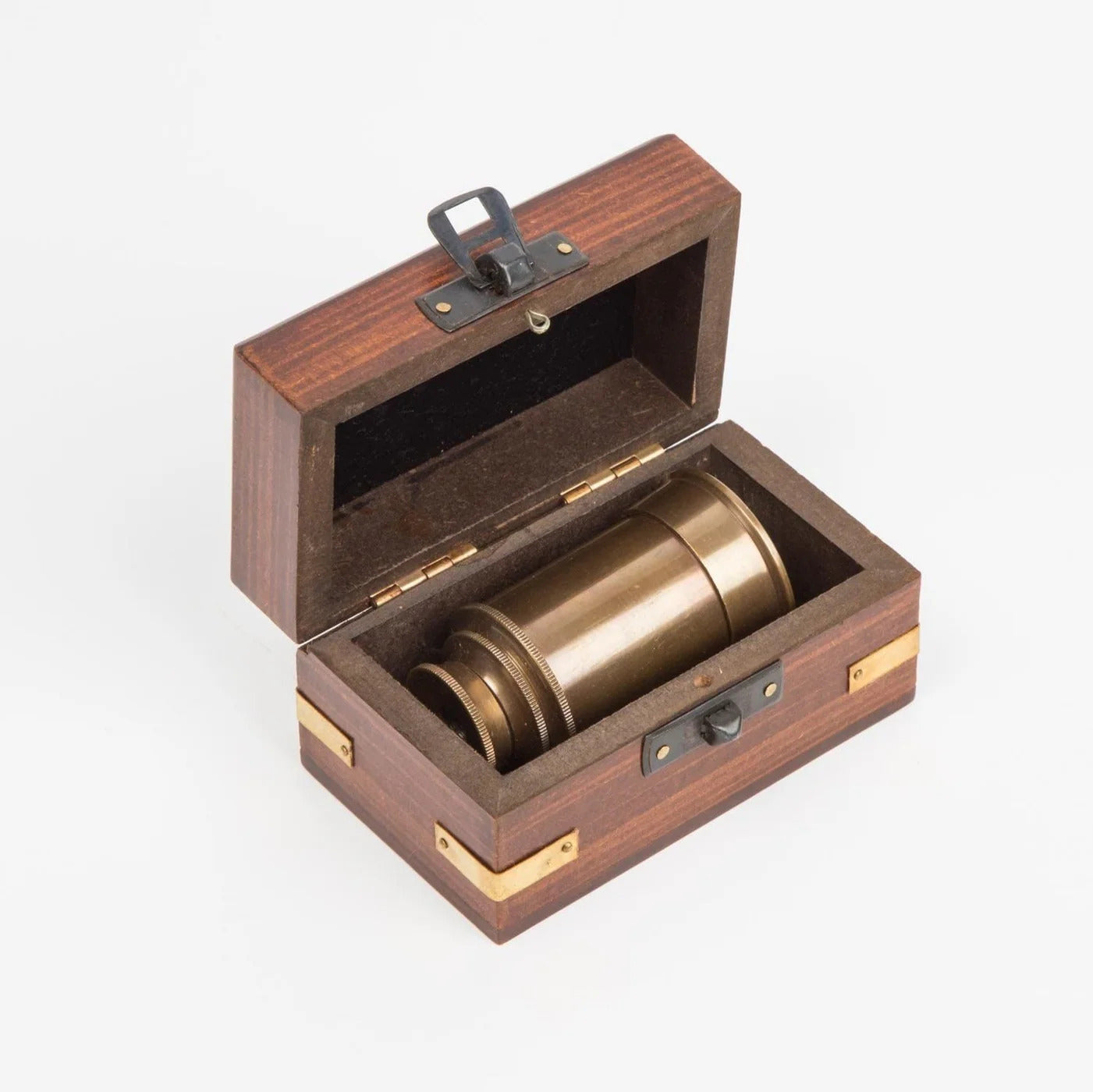 Brass cylindrical mini telescope in a wooden box on a white background
