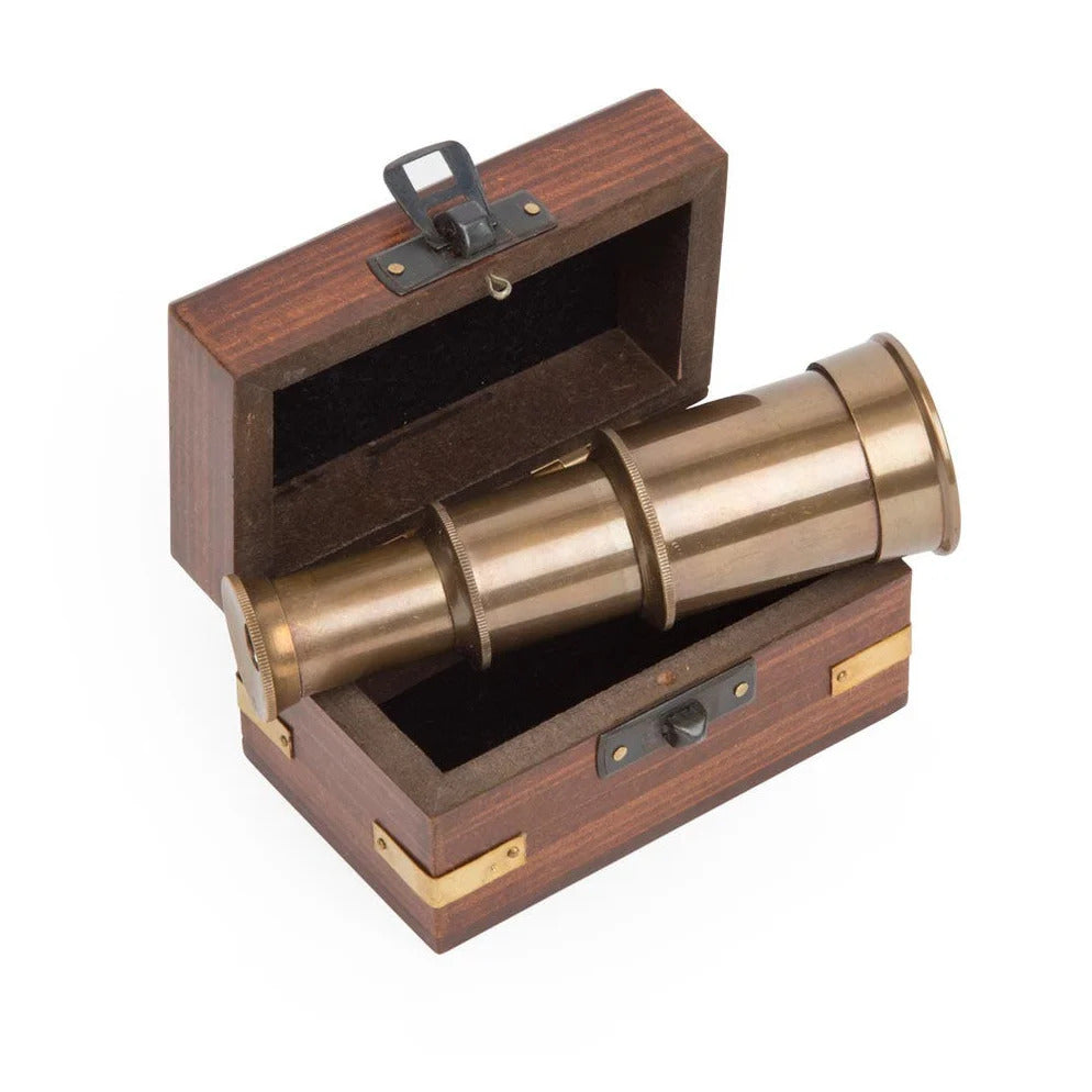 Brass telescope in a wooden box on a white background