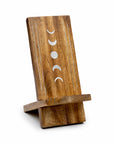 Wooden phone stand with moon phase design on a white background