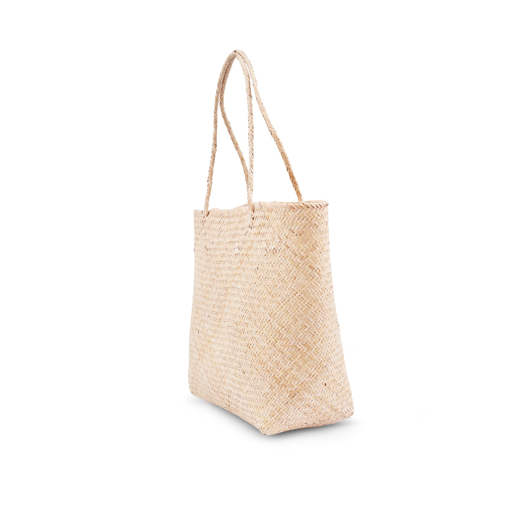 Side view of a beige rattan market tote bag with a shoulder strap.