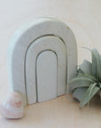 A handcarved arched natural stone sculpture