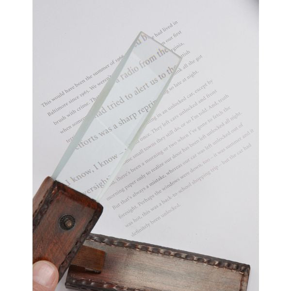 Magnifying glass with a leather handle on a book page