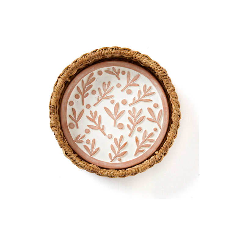 A terracotta bread warmer with an olive branch floral design, handmade from sustainable hogla grass, placed on a white background.