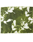 Green placemat with white floral pattern on a white background