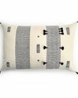 Decorative beige and black pillow case displayed against a white background