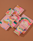 Colorful spiral-bound notebooks on a brown background