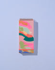 Notebook with colorful abstract design on a light blue background