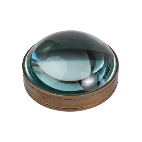 A round paperweight with a magnifying glass in antique brass color, featuring a glass center and a metallic brass outer ring.