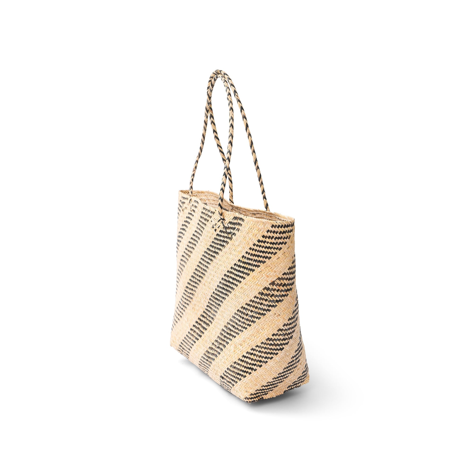 Side view of a natural rattan market tote with a geometric pattern and twin handles.