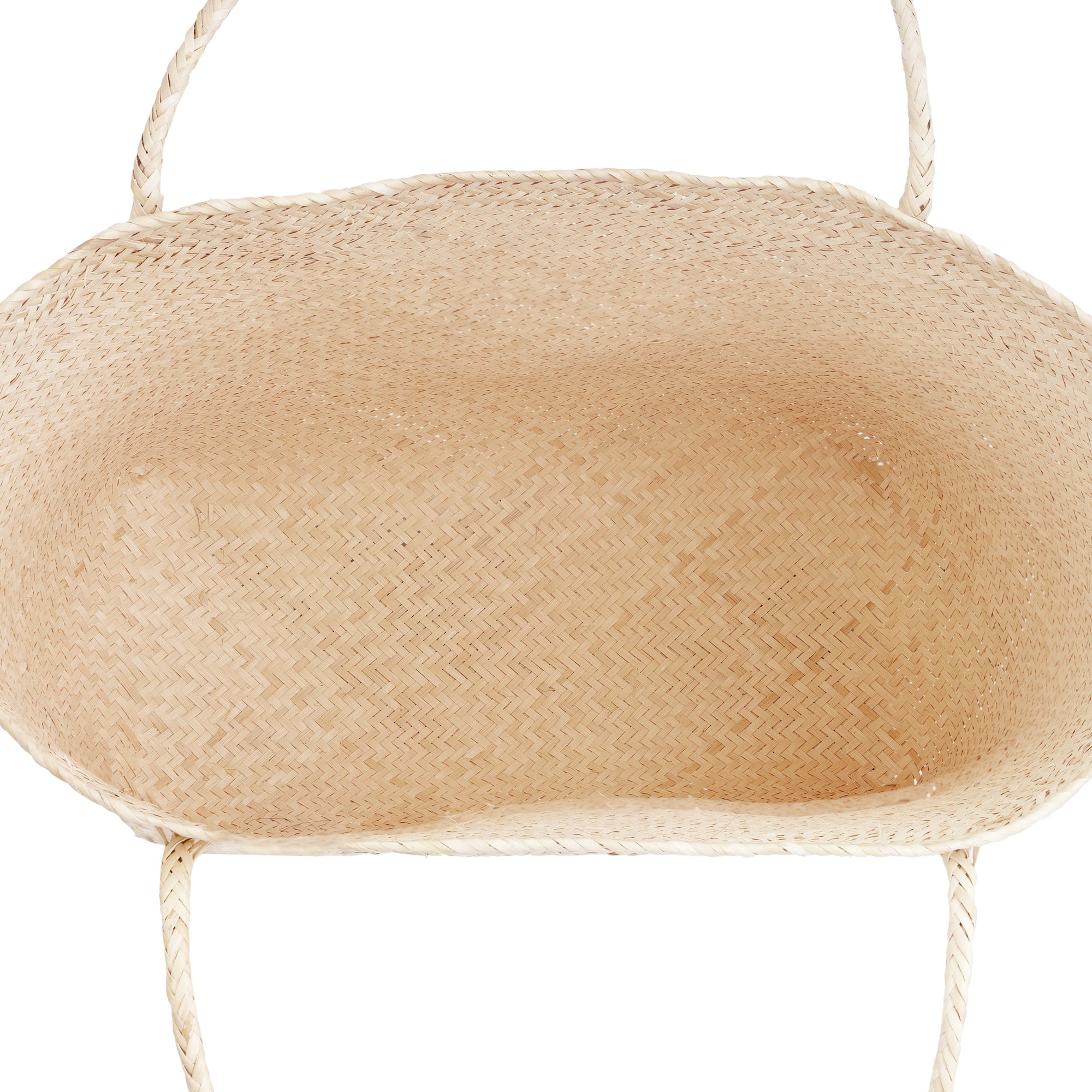 Inside of a beige rattan market tote bag with a shoulder strap.