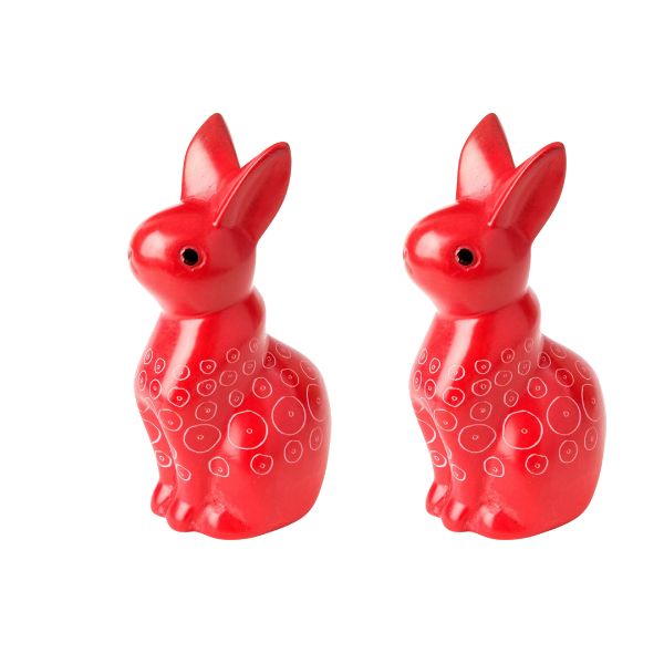 A pair of red soapstone carved bunny figurines with etched details