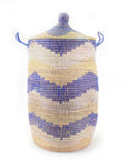 A large hamper basket with a lid, featuring a blue and natural chevron pattern, made from woven material.