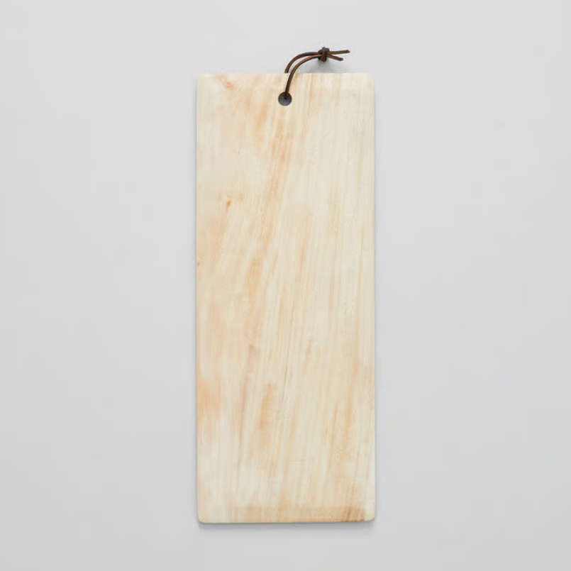 Cream colored wooden cutting or serving board displayed on a white background