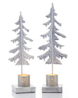 Partially-recycled metal pine in the shape of a tree on whitewashed wooden bases with a small die-cut lantern