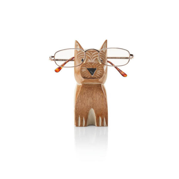 A hand-carved mango wood dog-shaped glasses holder with eyewear placed on it